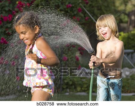 little boy spraying a little girl with the hose View Large Photo Image Stock Photo - little boy spraying a little girl with the hose. Fotosearch