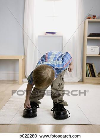 little boy wearing a man's shoes View Large Photo Image Stock Image - little boy wearing a man's shoes. Fotosearch