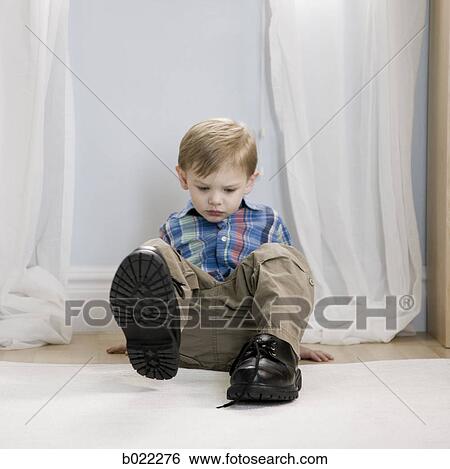 little boy wearing a man's shoes View Large Photo Image Stock Photograph - little boy wearing a man's shoes. Fotosearch