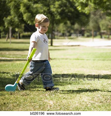 little boy with a toy golf club View Large Photo Image Stock Photograph - little boy with a toy golf club. Fotosearch