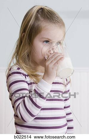 Picture - little girl eating breakfast. Fotosearch