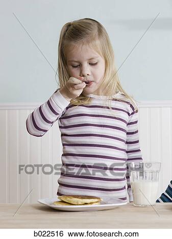 little girl eating breakfast View Large Photo Image Stock Photograph - little girl eating breakfast. Fotosearch