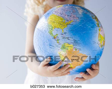 Stock Image - little girl holding a globe. Fotosearch