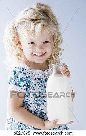 little girl holding a jug of milk View Large Photo Image Stock Photo - little girl holding a jug of milk. Fotosearch