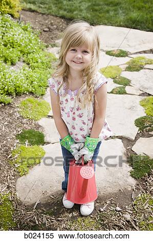 little girl holding a watering can View Large Photo Image Stock Photography - little girl holding a watering can. Fotosearch