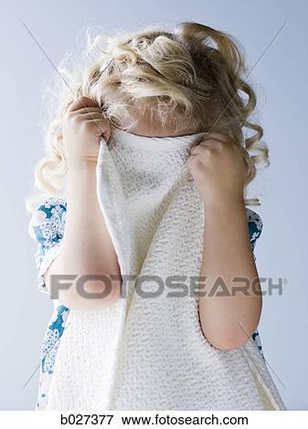 little girl holding her blanket in front of her face View Large Photo Image Stock Photo - little girl holding her blanket in front of her face. Fotosearch