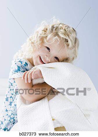 Stock Image - little girl holding her blanket. Fotosearch