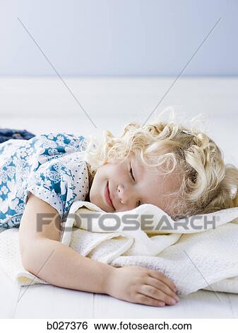 Stock Photograph - little girl holding her blanket. Fotosearch