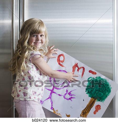 little girl holding up a drawing View Large Photo Image Stock Image - little girl holding up a drawing. Fotosearch