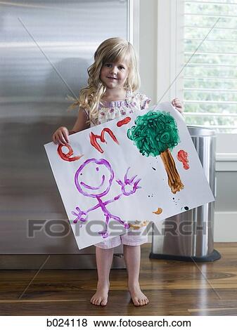 little girl holding up a drawing View Large Photo Image Stock Photo - little girl holding up a drawing. Fotosearch