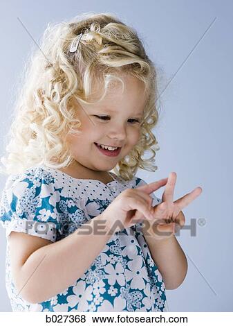 little girl holding up three fingers View Large Photo Image Stock Photo - little girl holding up three fingers. Fotosearch