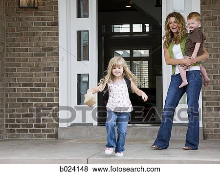 Stock Photo - little girl leaving for school as mother watches. Fotosearch