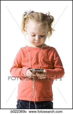 Stock Image - little girl listening to mp3 player. Fotosearch