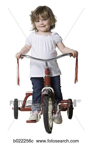 little girl on a tricycle View Large Photo Image Stock Image - little girl on a tricycle. Fotosearch
