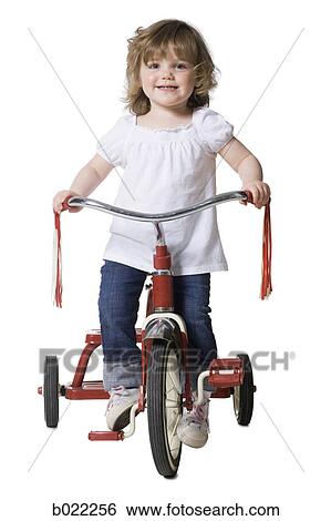 little girl on a tricycle View Large Photo Image Stock Photograph - little girl on a tricycle. Fotosearch