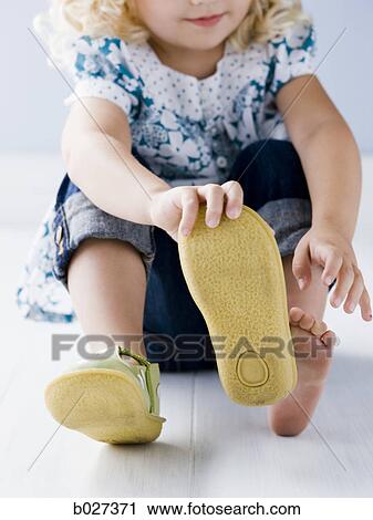 little girl putting on her shoes View Large Photo Image Stock Image - little girl putting on her shoes. Fotosearch