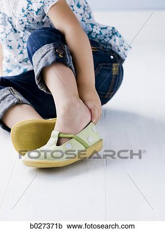 little girl putting on her shoes View Large Photo Image Stock Image - little girl putting on her shoes. Fotosearch