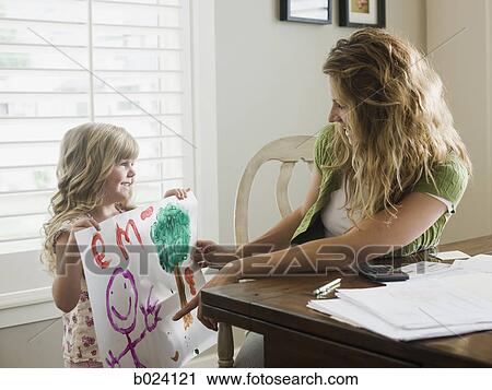 little girl showing her mother a drawing View Large Photo Image Stock Image - little girl showing her mother a drawing. Fotosearch