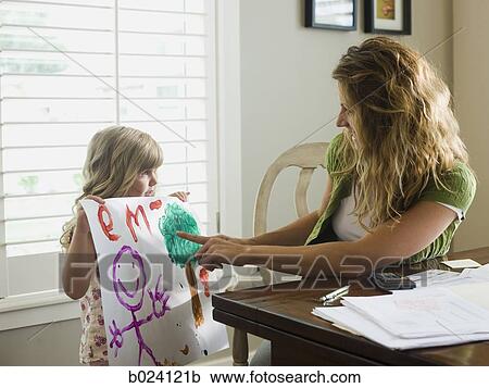 little girl showing her mother a drawing View Large Photo Image Stock Image - little girl showing her mother a drawing. Fotosearch