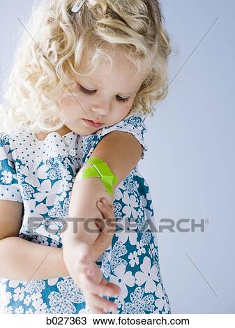 little girl with a bandaid on her arm View Large Photo Image Stock Image - little girl with a bandaid on her arm. Fotosearch