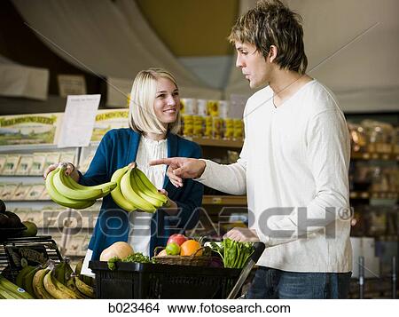 man and woman at the supermarket View Large Photo Image Picture - man and woman at the supermarket. Fotosearch