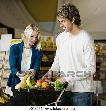 Stock Photography - man and woman at the supermarket. Fotosearch