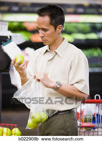 Stock Image - man at the grocery store. Fotosearch