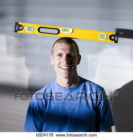man balancing a level on his head View Large Photo Image Stock Photograph - man balancing a level on his head. Fotosearch