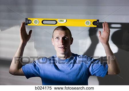 man balancing a level on his head View Large Photo Image Stock Photography - man balancing a level on his head. Fotosearch