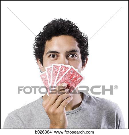 man covering his face with playing cards View Large Photo Image Picture - man covering his face with playing cards. Fotosearch