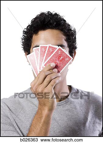man covering his face with playing cards View Large Photo Image Stock Image - man covering his face with playing cards. Fotosearch