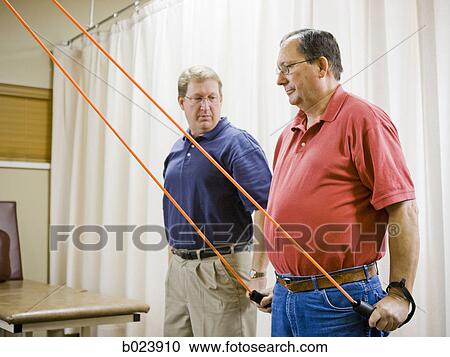 man doing physical therapy View Large Photo Image Stock Image - man doing physical therapy. Fotosearch