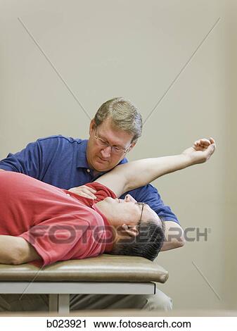 Stock Image - man doing physical therapy. Fotosearch