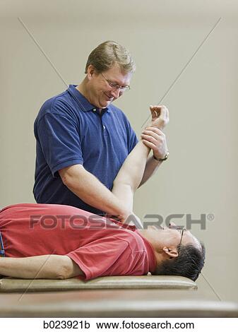 man doing physical therapy View Large Photo Image Stock Image - man doing physical therapy. Fotosearch