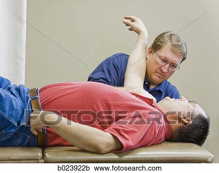 Stock Image - man doing physical therapy. Fotosearch