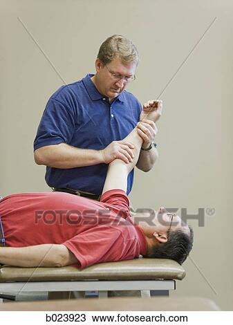 man doing physical therapy View Large Photo Image Stock Image - man doing physical therapy. Fotosearch