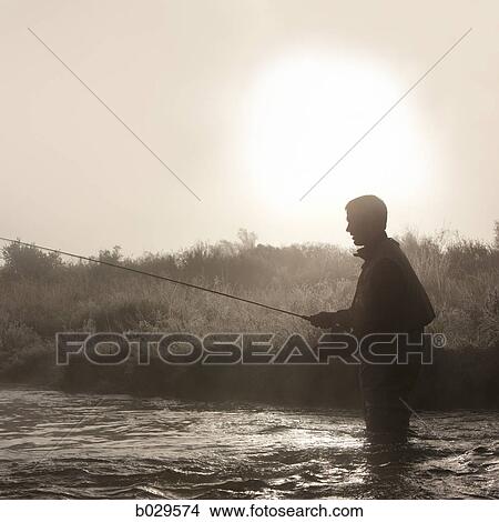 man fishing in a river View Large Photo Image Picture - man fishing in a river. Fotosearch