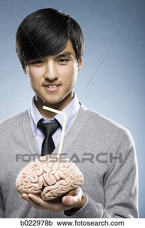 man holding a brain with a drinking straw sticking out of it View Large Photo Image Stock Image - man holding a brain with a drinking straw sticking out of it. Fotosearch