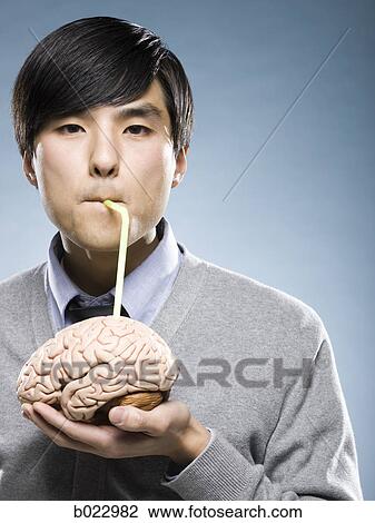 man holding a brain with a drinking straw sticking out of it View Large Photo Image Stock Image - man holding a brain with a drinking straw sticking out of it. Fotosearch
