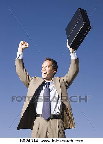 Picture - man holding a briefcase. Fotosearch