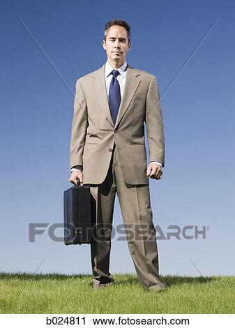 man holding a briefcase View Large Photo Image Stock Image - man holding a briefcase. Fotosearch