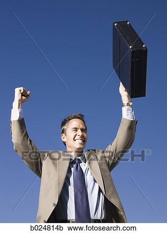 Stock Image - man holding a briefcase. Fotosearch