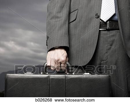Stock Photo - man holding a briefcase. Fotosearch