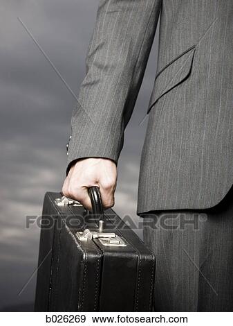 man holding a briefcase View Large Photo Image Stock Photo - man holding a briefcase. Fotosearch