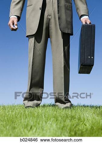 man holding a briefcase View Large Photo Image Stock Photograph - man holding a briefcase. Fotosearch