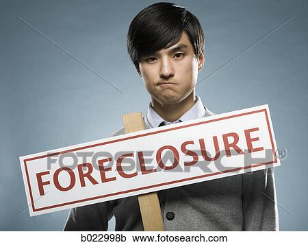 man holding a foreclosure sign View Large Photo Image Stock Image - man holding a foreclosure sign. Fotosearch