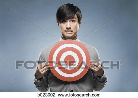 man holding a target View Large Photo Image Stock Image - man holding a target. Fotosearch