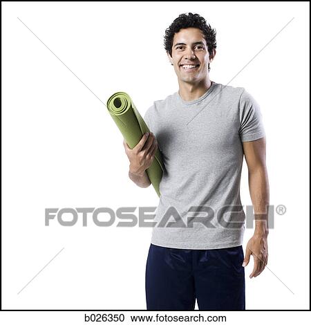 man holding a yoga mat View Large Photo Image Stock Image - man holding a yoga mat. Fotosearch