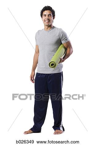 man holding a yoga mat View Large Photo Image Stock Photo - man holding a yoga mat. Fotosearch
