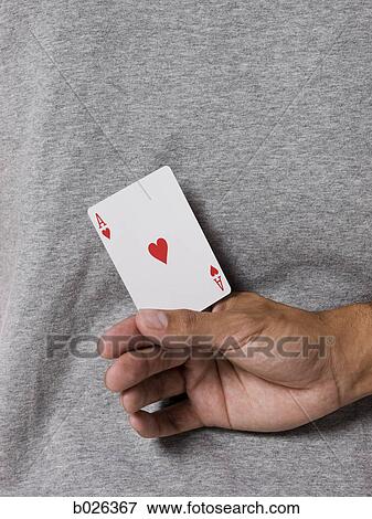man holding an ace card behind his back View Large Photo Image Stock Photo - man holding an ace card behind his back. Fotosearch